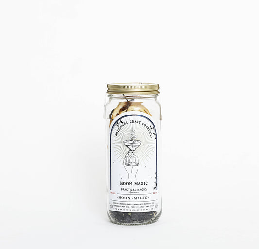 A glass jar containing Moon Magic Craft Cocktail / Mocktail Kit with a label depicting a wizard and product details.