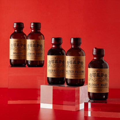 Set of five brown bottles with labels on a red background