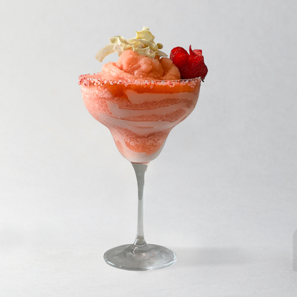 Frothy pink drink in a glass with whipped cream and berries on a white background