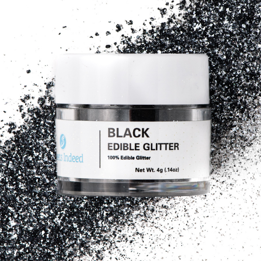 Jar of black edible glitter with a white label on a glittery background
